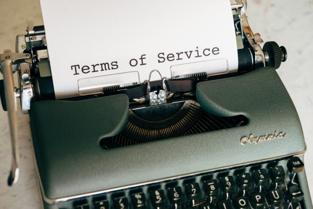 black and white braille typewriter with terms of service written on the paper