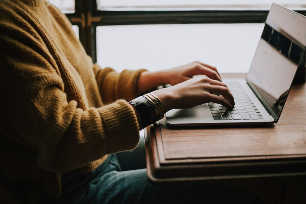 person sitting front of laptop looking for ministays host cancellation policy