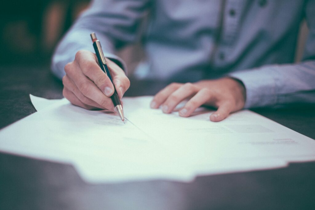 man writing a policy on paper