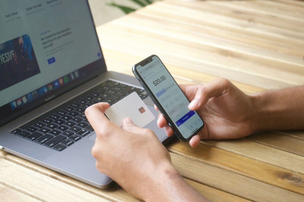 person using laptop computer and entering credit card information to make a payment